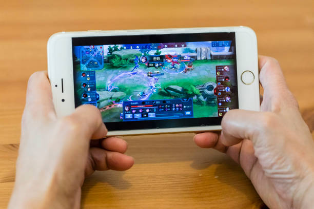 HONG KONG, HONG KONG - SEPTEMBER 11: A teenager plays Wangzhe Rongyao, variably known in English unofficial translations as King of Glory, a multiplayer online battle arena developed and published by Tencent Games for the iOS and Android mobile platforms, exclusively for the Chinese market, in Hong Kong, Hong Kong on September 11, 2018. (Photo by Yu Chun Christopher Wong/S3studio/Getty Images)